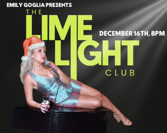 A blonde woman wearing a Santa hat sings into a microphone