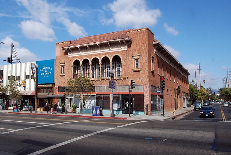 Brick building housing HIghland Park, Los Angeles Masonic Lodge built in 1922. California Blue sky with puffy white clouds in the background.