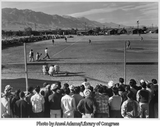 People watch a baseball game at the Manzanar camp in the Eastern Sierras photo by Ansel Adams/Library of congress