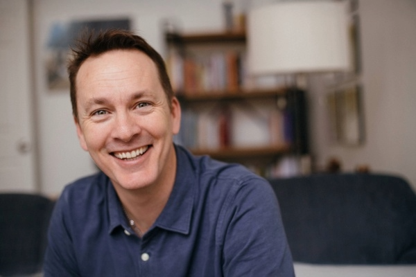Smiling man in blue shirt - Jay Sefton