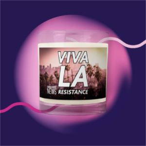 an unscented candle in a glass jar with the words Viva LA Resistance with downtown LA skyline in background