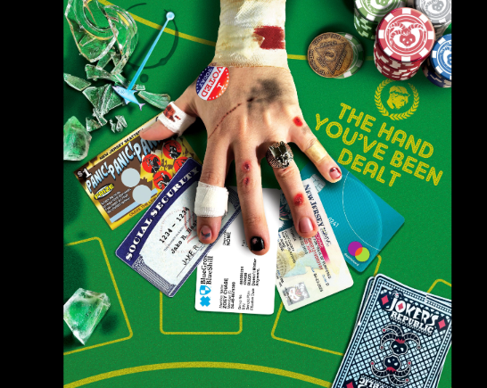 beat up hand on a poker table gambling with US social benefits cards