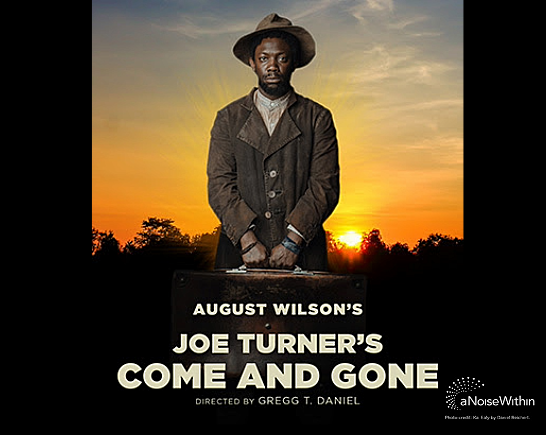 A black man stands before a table with his hands in in fists bound in front of him. He wears a tan suit, a white collared shirt and a tan brimmed hat. It is a poster for August Wilson's play Joe Turner's Come and Gone