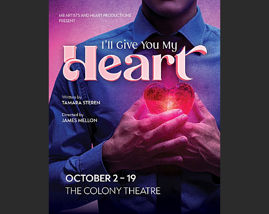 A man with a dress shirt and tie holds a glowing heart in his hands