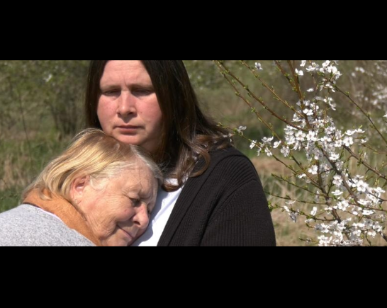 A young woman with long dark hair embraces an older woman with blonde hair in the film Mama's Voice