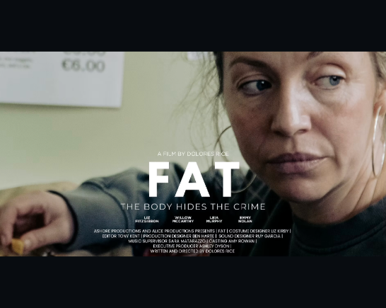 Show poster for short film FAT is image of woman with blonde hair glancing over her shoulder with her right arm outstretched resting on a table.