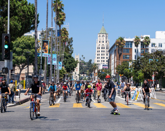 People on bikes, skateboards and scooters ride down Highland Avenue in Hollywood during CicLAvia