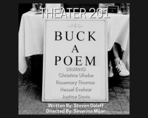 Table draped with white tablecloth has typewriter and sign that says "Poems $1" A leg with white ankle high socks and a black and white sneaker sticks out from beneath the table cloth