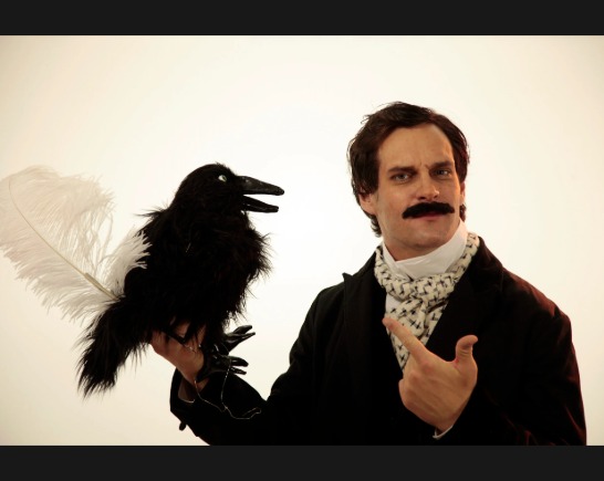Lit-hop artist MC LARS wears a cravat and holds a stuffed raven and a long white quill