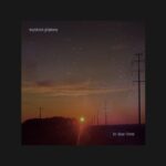 A midwestern sunset at twilight with stars in the sky and setting orange sun