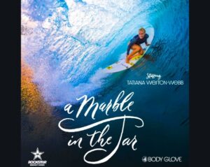 Pro female surfer Tatiana Weston-Webb rides a giant wave